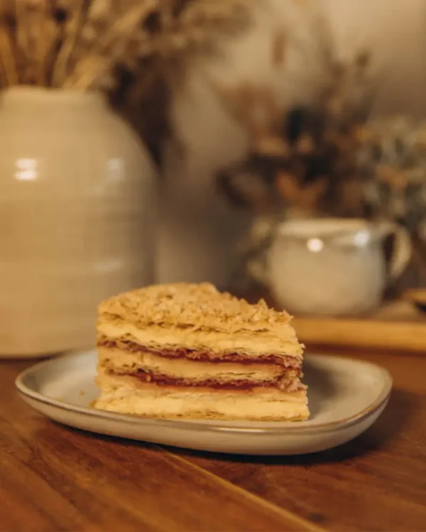 Pistachio Napoleon Slice with Raspberry Slice of Napoleon with raspberry on a plate